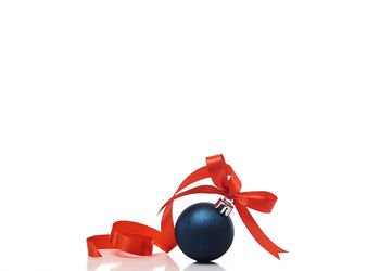 Close-up of christmas decorations over white background