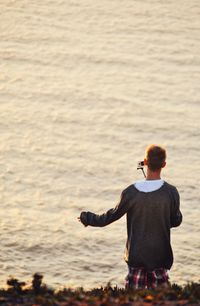 Rear view of man looking at sea