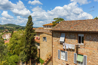 Italian residential building in a city with hanging laundry between the windows