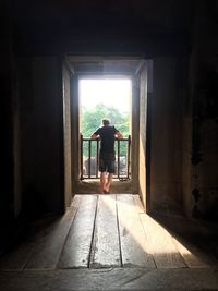 Rear view of man standing in corridor