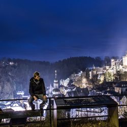 Man working in city at night