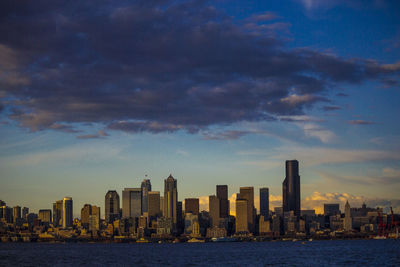 Sea and cityscape against dramatic sky