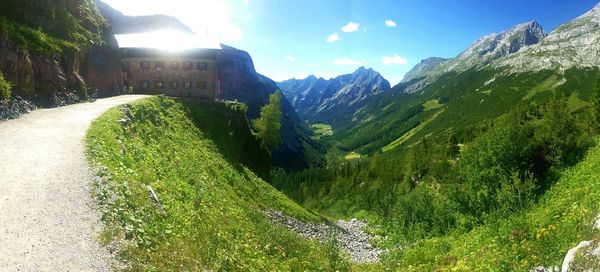 Panoramic view of green landscape against sky