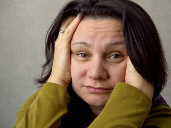 Close-up portrait of woman against wall