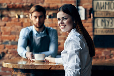 Portrait of a smiling young man with coffee cup