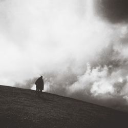 Silhouette of woman against sky