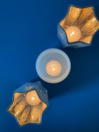 Low angle view of illuminated lamp against black background