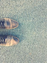 Low section of man standing on tiled floor