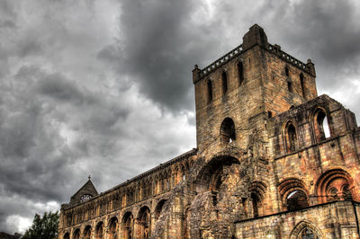 Low angle view of historical building against cloudy sky