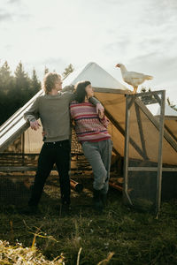 Rear view of woman standing on field