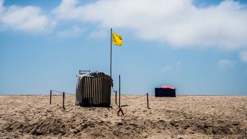 Lifeguard hut on beach against sky