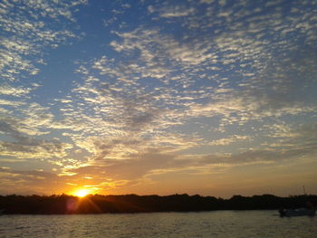 Scenic view of calm sea at sunset