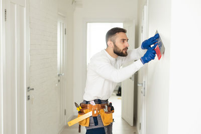 Side view of man working at home