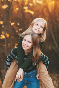 Portrait of a smiling young woman during autumn