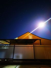 Low angle view of illuminated building against sky at night