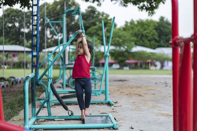 Boy swinging at playground