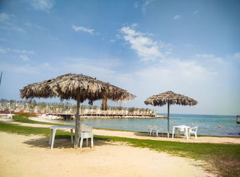 Lifeguard hut on beach against sky