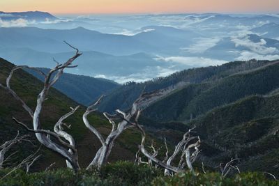 Scenic view of mountains against cloudy sky