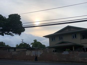 Houses against sky during sunset