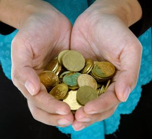 Close-up of hand holding coins