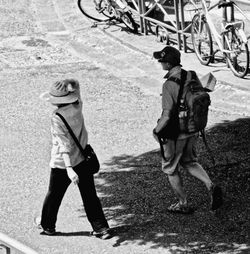 Rear view of woman standing on footpath