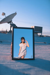 Full length of girl and woman against clear sky