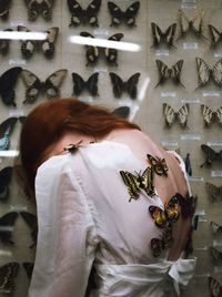 Rear view of woman with text on glass