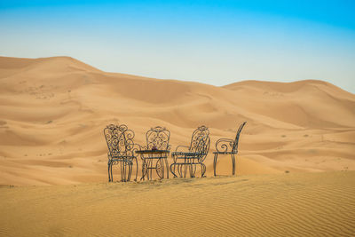 Scenic view of desert against clear blue sky