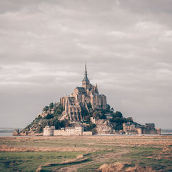 View of temple building against cloudy sky