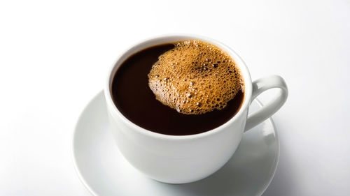 High angle view of coffee cup against white background