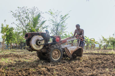 Tractor on field against sky