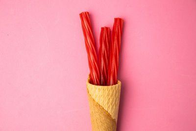 Close-up of colored pencils against pink background