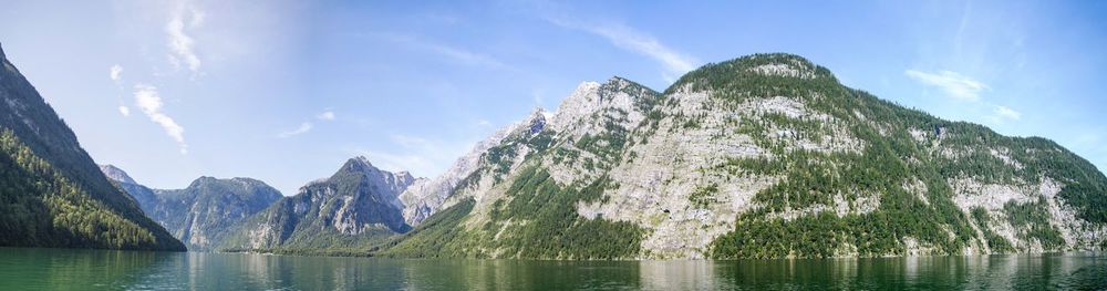 Scenic view of sea and mountains against sky