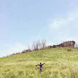 Man walking on grassy field