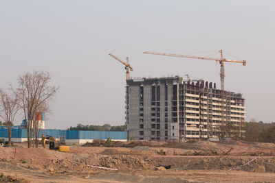 Crane at construction site against sky