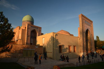 Group of people in front of historic building