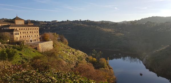 High angle view of lake by buildings against sky