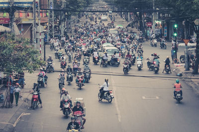 High angle view of people riding motorcycle at street