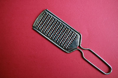 High angle view of computer keyboard on red table