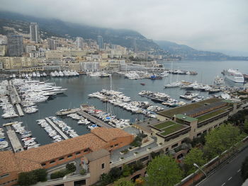 High angle view of cityscape by sea against sky