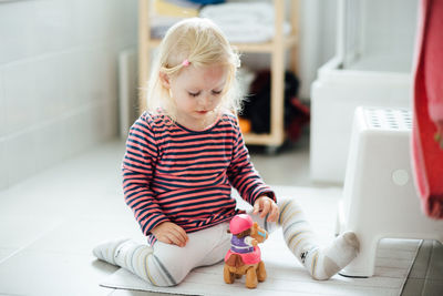 Cute boy using mobile phone at home