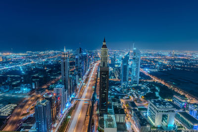 High angle view of illuminated cityscape against sky at night