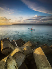 Man on boat fishing in sea