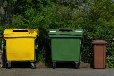 Garbage bin against trees and plants