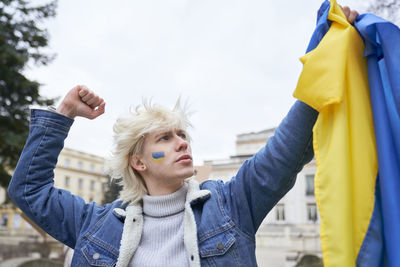 Young man holding ukrainian flag