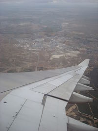 Airplane wing over landscape