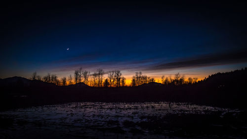 Scenic view of silhouette landscape against sky at sunset