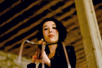 Close-up of young woman standing at night