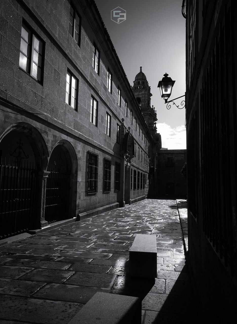 built structure, building exterior, architecture, street, building, city, no people, nature, sky, direction, day, the way forward, street light, sunlight, outdoors, shadow, window, footpath, arch, residential district