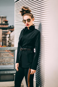 Young woman wearing sunglasses standing outdoors